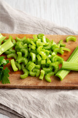 Raw Green Organic Celery on a rustic wooden board, low angle view.