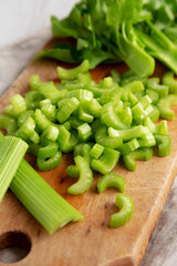 Raw Green Organic Celery on a rustic wooden board, low angle view. Close-up.