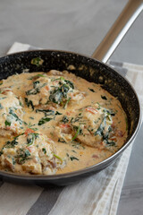 Homemade Creamy Tuscan Chicken with Spinach in a Pan, side view.