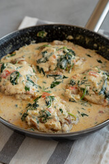 Homemade Creamy Tuscan Chicken with Spinach in a Pan, side view.