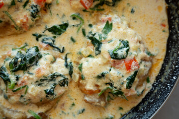 Homemade Creamy Tuscan Chicken with Spinach, top view. From above, overhead, flat lay. Close-up.