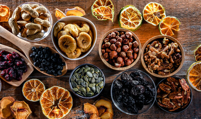Composition with a variety of dried fruits and assorted nuts.