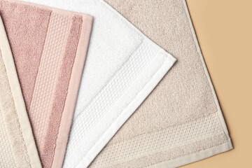 Folded soft towels on beige background