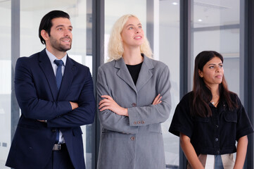 Young businessman and employee standing and smiling in office.