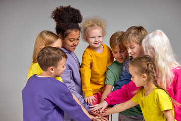 Group of smiling kids are ready to support and help each other isolated white background - obrazy, fototapety, plakaty