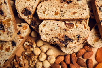 Delicious biscotti cookies and nuts on board, closeup