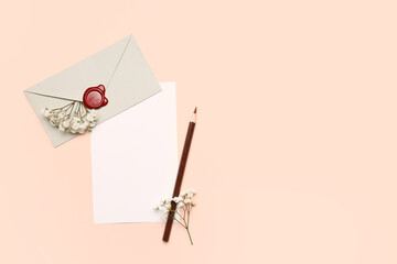 Composition with blank card, envelope, pencil and gypsophila flowers on color background