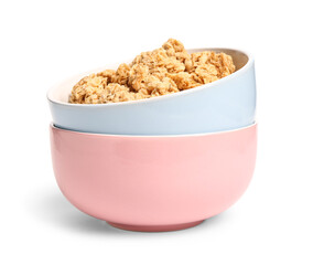 Bowls of tasty granola on white background