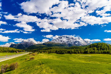 Fototapeta na wymiar Road with Alps mountains, Samedan, Maloja Graubuenden Switzerland