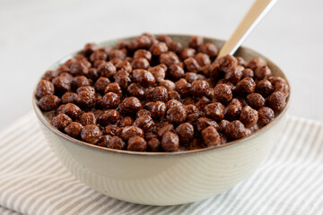 Chocolate Puff Cereal with Milk in a Bowl, side view.