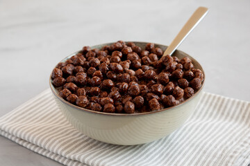 Chocolate Puff Cereal with Milk in a Bowl, side view.