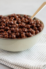 Chocolate Puff Cereal with Milk in a Bowl, low angle view.