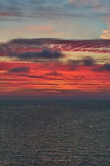 Vertical shot of a gorgeous fiery sunset sky above the calm sea on the Ramsgate coast