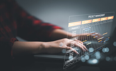 Planning and Implementation, Business people use laptop computers to manage work projects and update tasks. Work progress, efficient scheduling.Business Data Management scheduling interface

