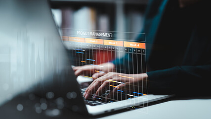 Planning and Implementation, Business people use laptop computers to manage work projects and update tasks. Work progress, efficient scheduling.Business Data Management scheduling interface

