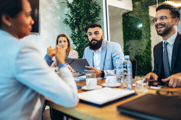 Group of businesspeople having a briefing in a boardroom. Businesspeople working together in a modern workplace.