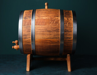 Wooden barrel on table near green wall