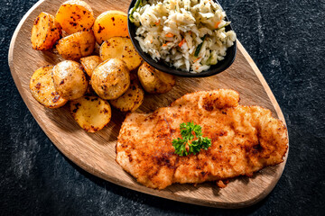 Chicken cutlet coated with breadcrumbs with potatoes and cabbage