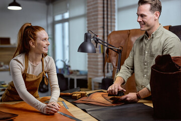 young happy excited leather enthusiast spend most of his free time crafting, researching.happiness positive atmosphere at workshop, success luck