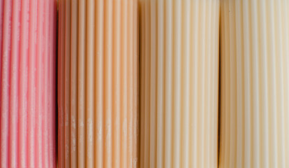 Obraz premium A cylindrical candle made of soy wax. Colour background