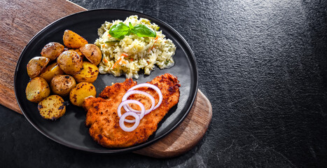 Chicken cutlet coated with breadcrumbs with potatoes and cabbage