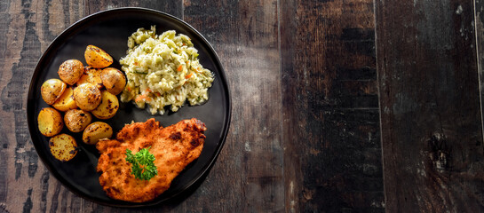 Chicken cutlet coated with breadcrumbs with potatoes and cabbage