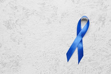 Blue awareness ribbon on light background. Prostate cancer concept