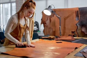 hardworking artisan concentrated on keeping leather in good shapeclose up side view portrait. copy...