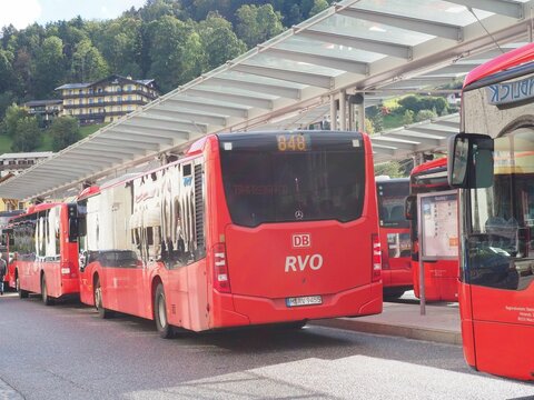 Red RVO Deutsche Bahn public buses waiting at a station in Berchtesgaden, Germany