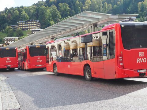 Red RVO Deutsche Bahn public buses waiting at a station in Berchtesgaden, Germany