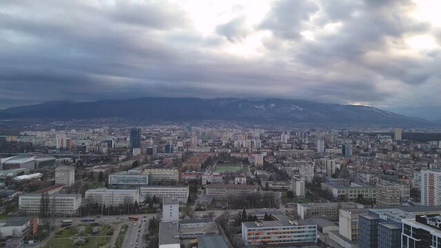 Aerial view of Sofia (Bulgaria) city, captured from eastern parts of the city with the Vitosha mountain on the background, during dramatic weather