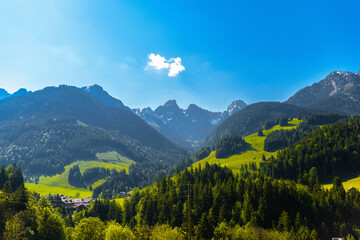 Mountains with meadows, forest and blue sky in Flendruz, Rougemont, Pays-d'Enhaut, Vaud, Switzerland