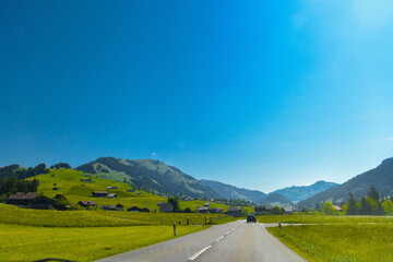 Road and green meadows, Gruyere, Fribourg Switzerland