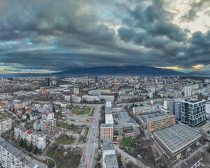 Obraz premium High resolution panorama from a drone, of eastern part of Sofia (Bulgaria) city, with the Vitosha mountain on the backround, during dramatic wheather
