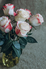 bouquet with roses in a vase on the table close-up