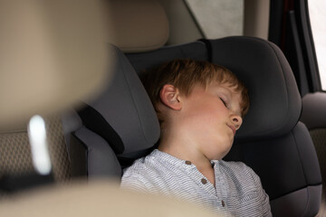 Little boy sleeping in a car seat. Security for children. Safety protection concept  for kids in...