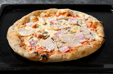 Frozen Chicken, Bacon, Mushroom Pizza on Dark Background, Stone Baked Pizza Ready to Bake