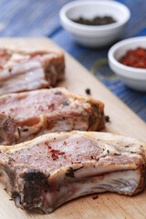 Raw pork meat on a cutting board and spices.