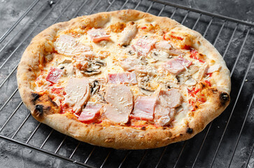 Frozen Chicken, Bacon, Mushroom Pizza on Dark Background, Stone Baked Pizza Ready to Bake
