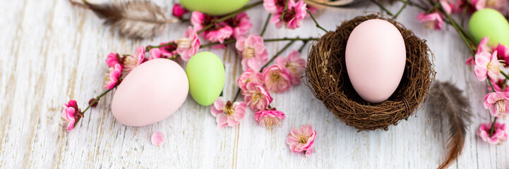 Stylish background with colorful easter eggs on white wooden background with copy space