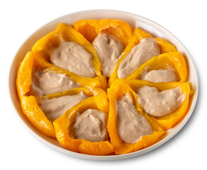 Cooked yellow peppers stuffed with Bagna caoda sauce, a cream made with anchovies, garlic, olive oil typical of Piedmont, Italy in white plate