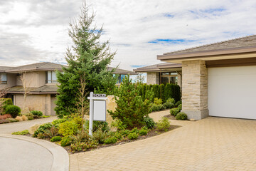 Obraz premium House For Sale. Real Estate Sign in Front of a House. Sold.