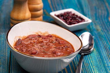 Healthy bean soup with red beans, Homemade Soup on blue wooden background , Vegetarian Food.