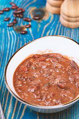 Healthy bean soup with red beans, Homemade Soup on blue wooden background , Vegetarian Food.
