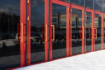 red glass door leading to the building