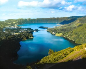 Fototapeta na wymiar Aerial landscape of lake between green hills on a sunny day