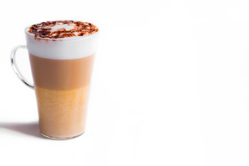 Latte macchiato in a tall glass on a white background. Cafe latte layered with milk in a high drinking glass. Minimalism. Сopy space