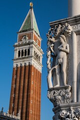 Fototapeta na wymiar View of tower building behind sculpture in Venice