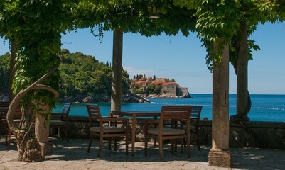Distant view of the Sveti Stefan island on a sunny day in Montenegro, Balkans