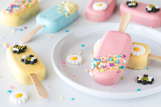 An arrangement of homemade cakesicles decorated for Spring.